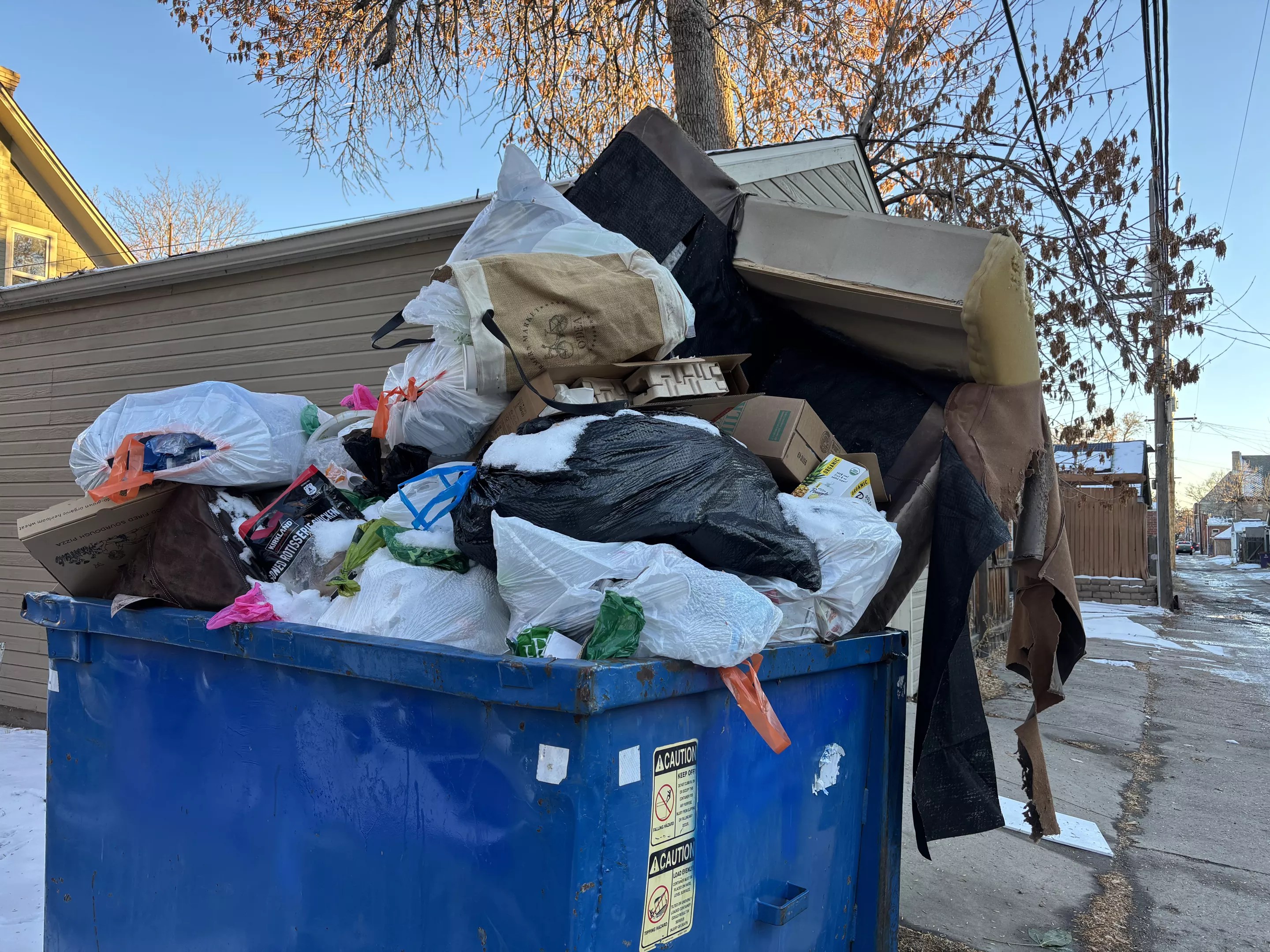 overflowing trash form dumpster