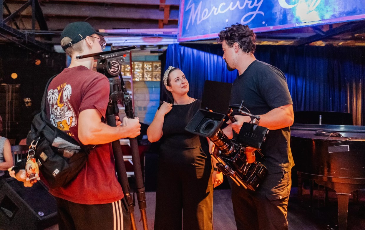 Three filmmakers standing in a room