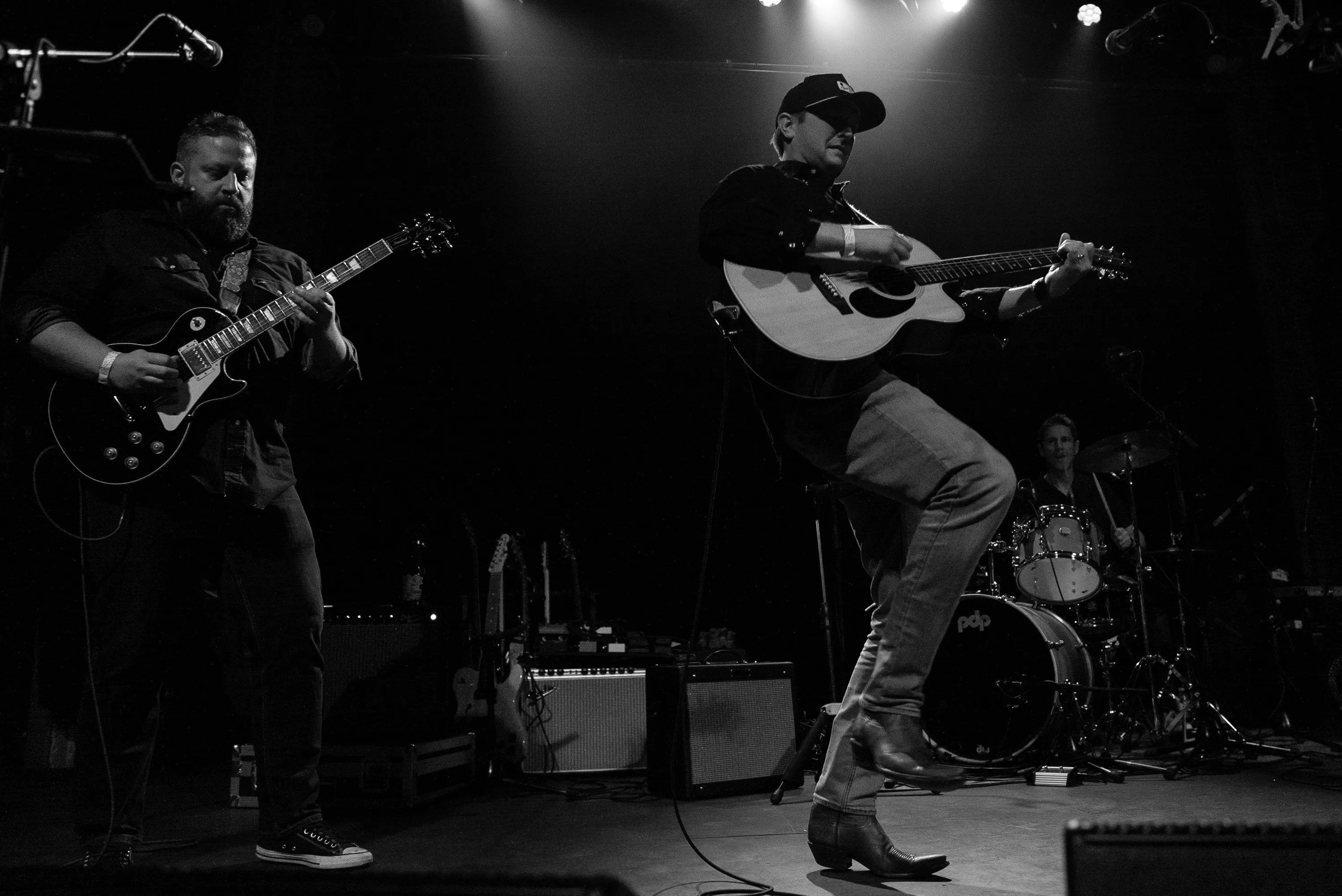 two men on stage playing guitar