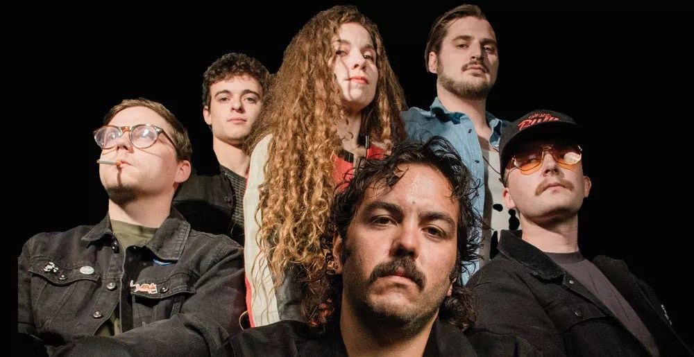 bandmates look into the camera