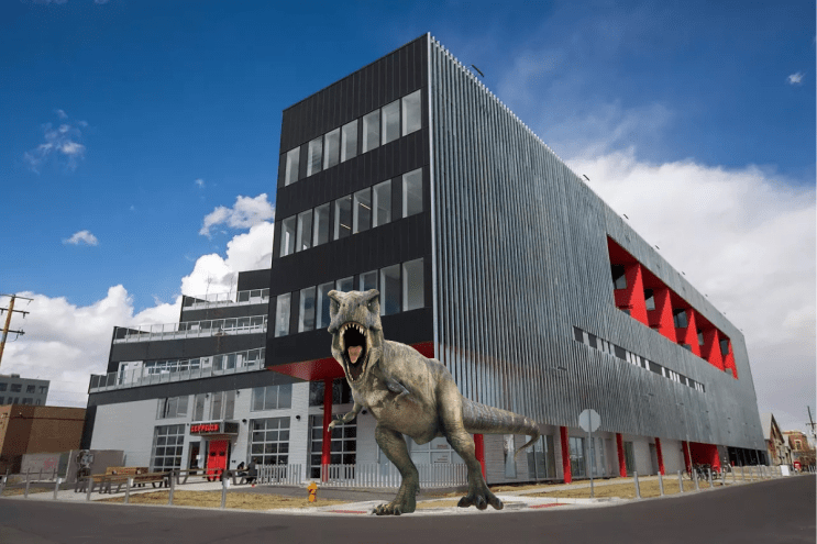 dinosaur in front of a building