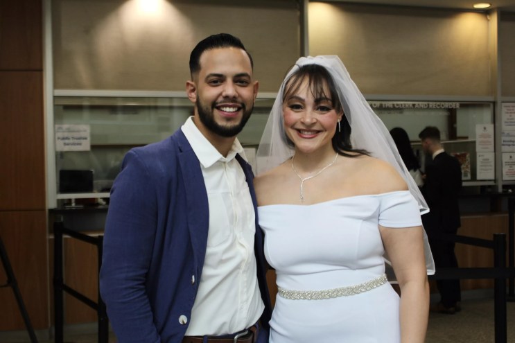 A bride and groom smile