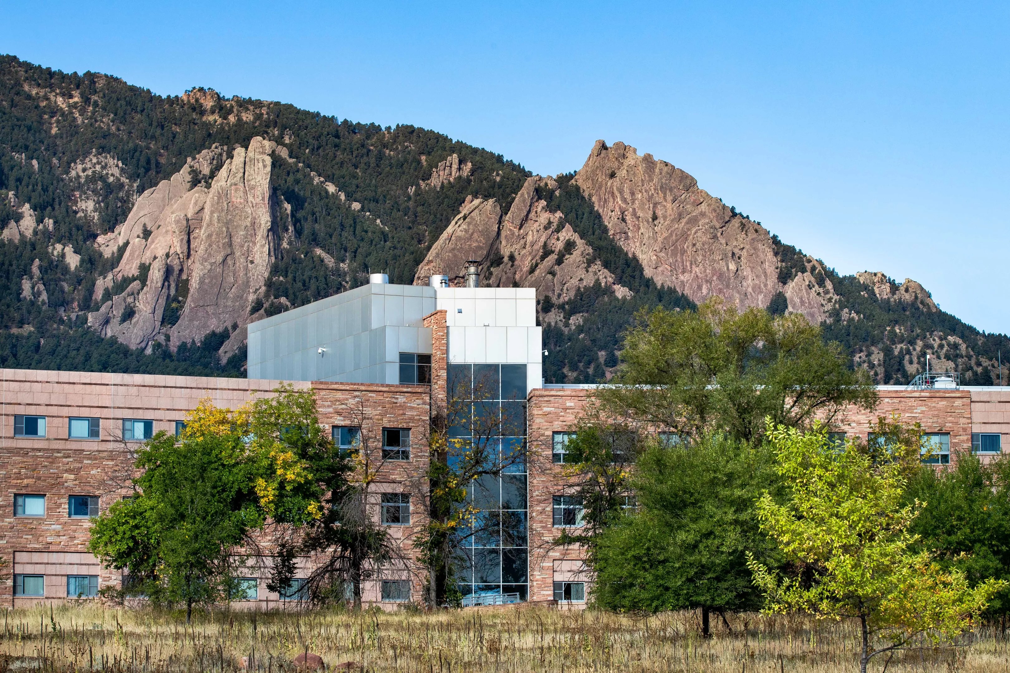 brick building against mountains, blue sky