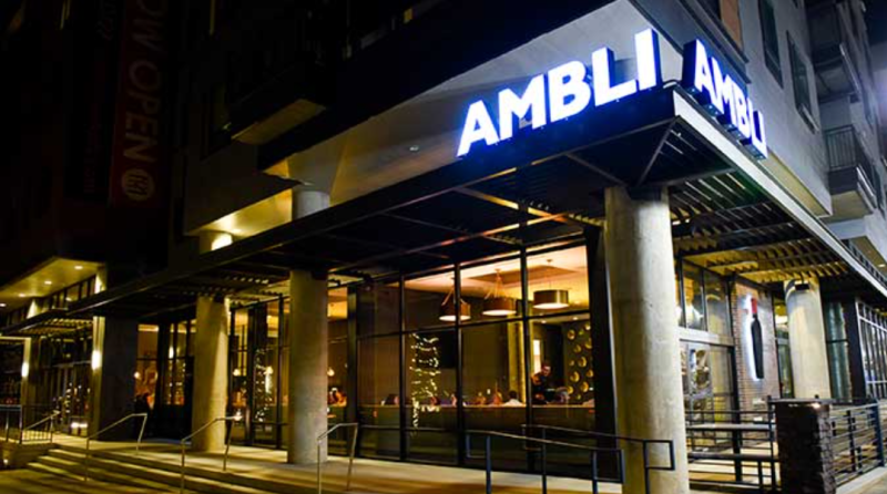 lit "ambli" sign over the front of a restaurant