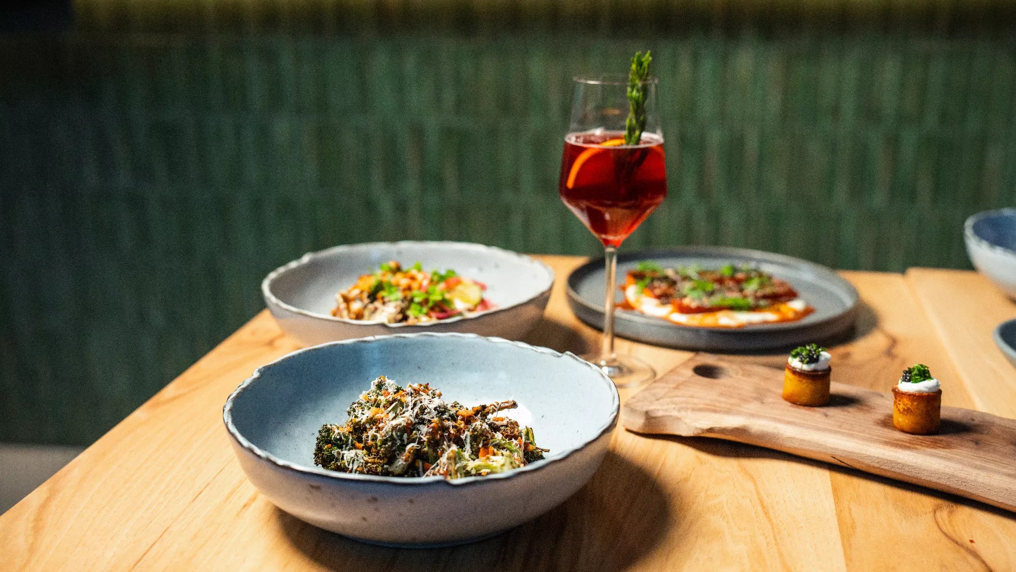 glass of wine and various dishes on a table