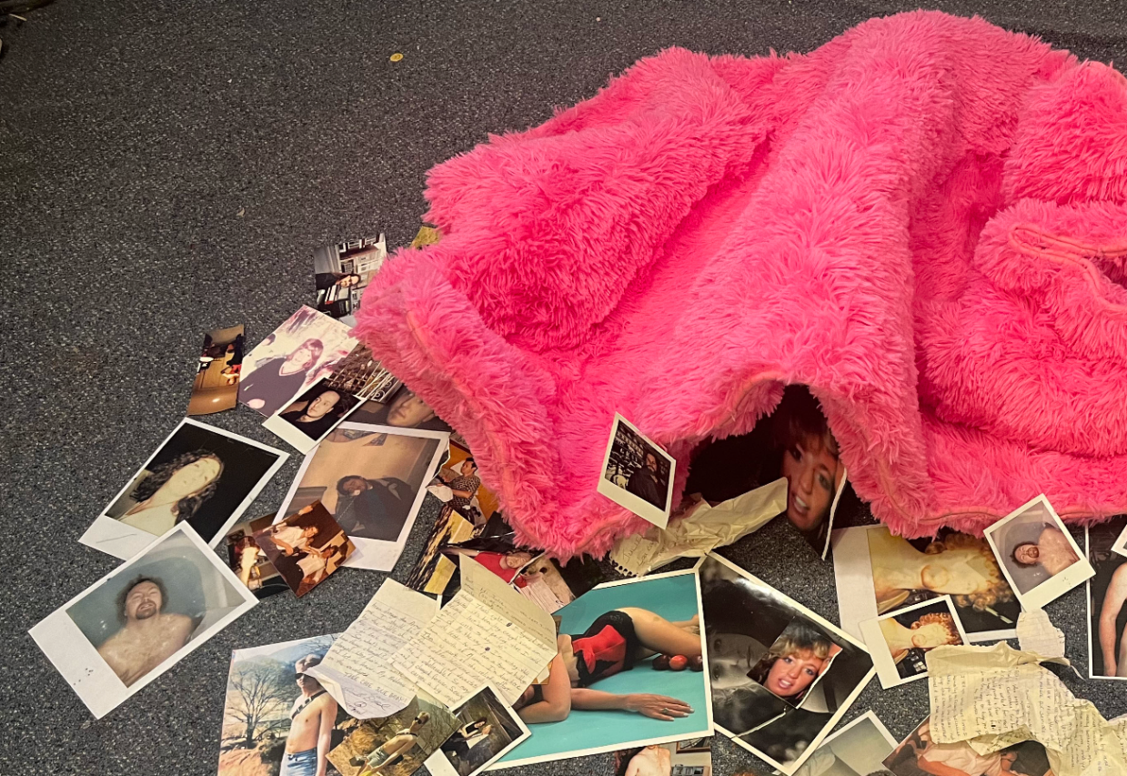 A pink shag rug surrounded by photos and letters