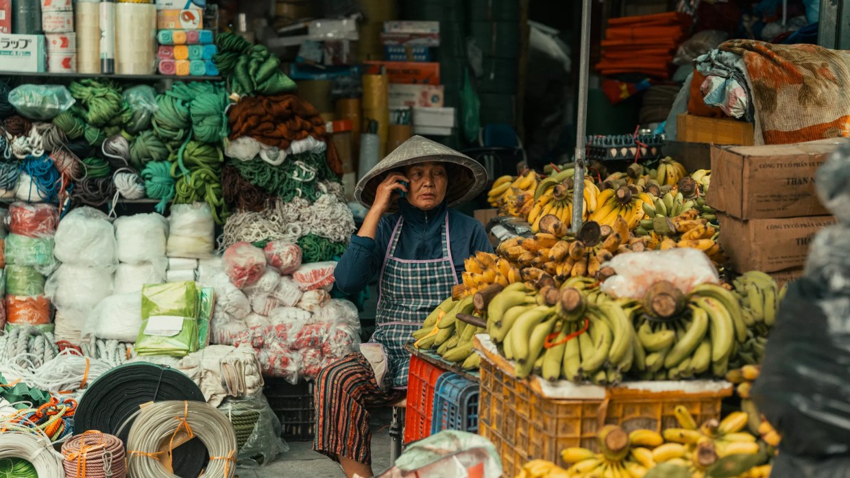 Woman talks on the phone in a market.