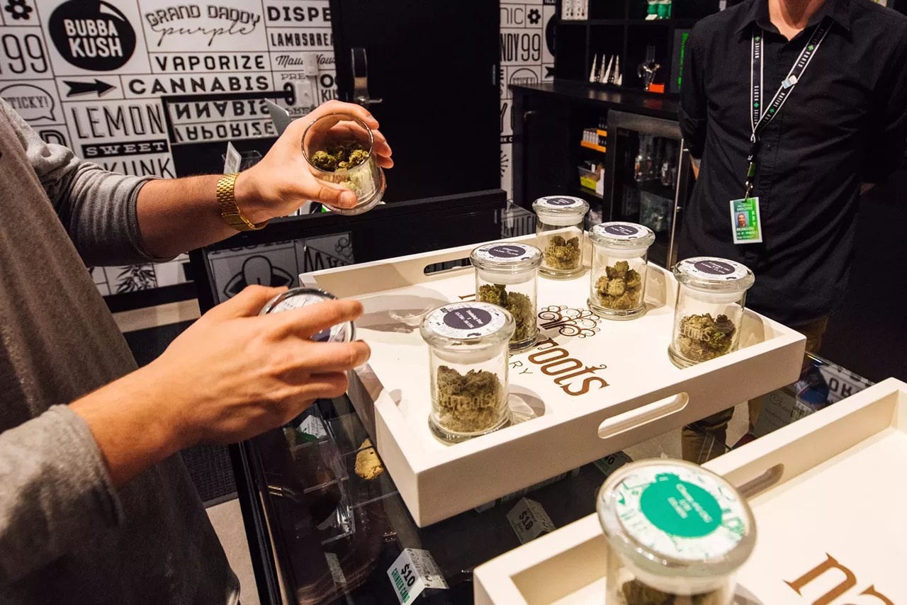 Dispensary budtender shows off marijuana samples
