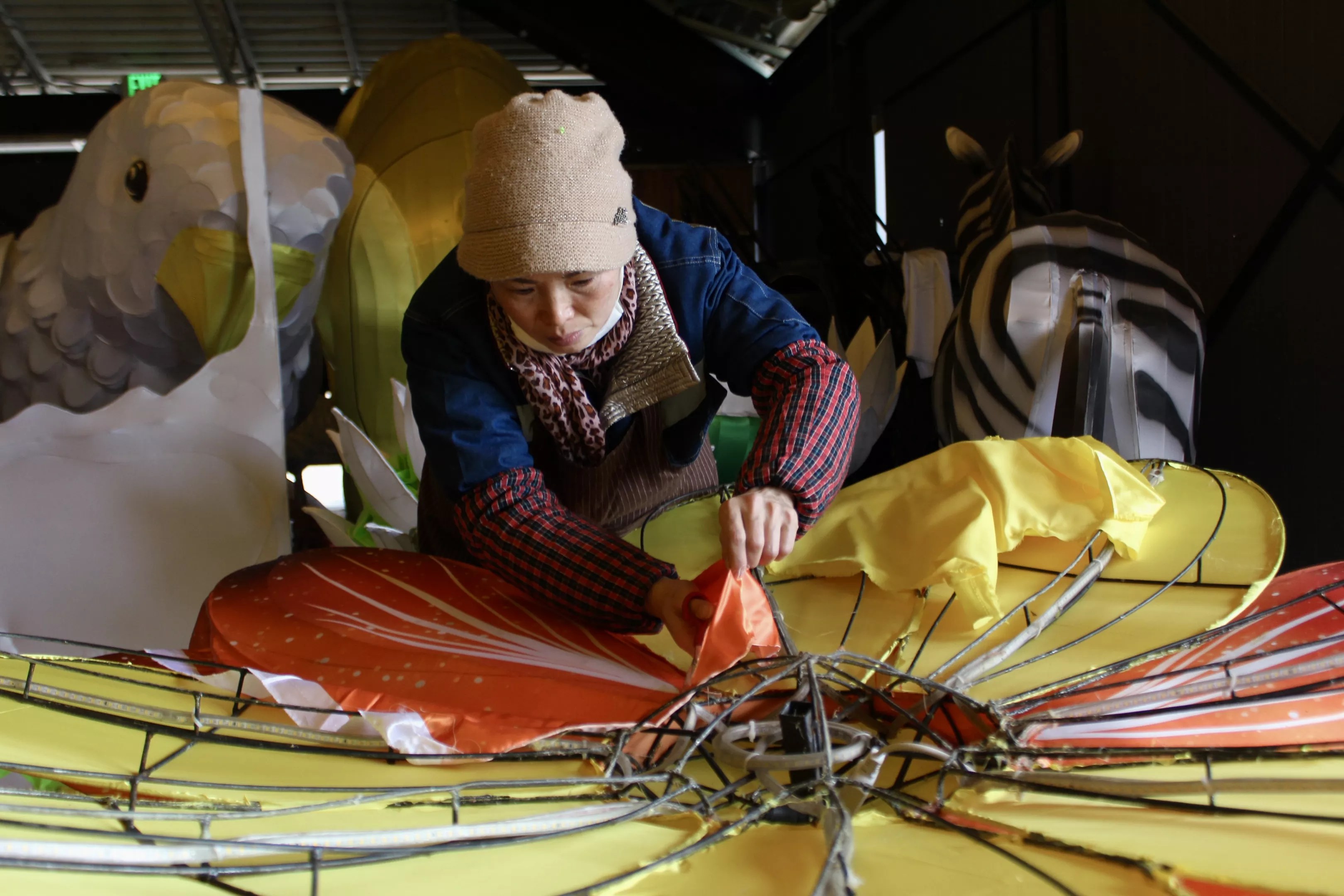 A woman paints a giant cloth flower