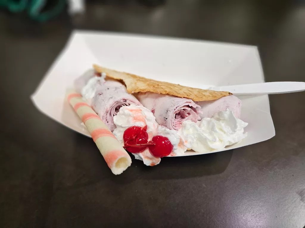 house-made waffle, strawberry ice cream, and whipped cream.