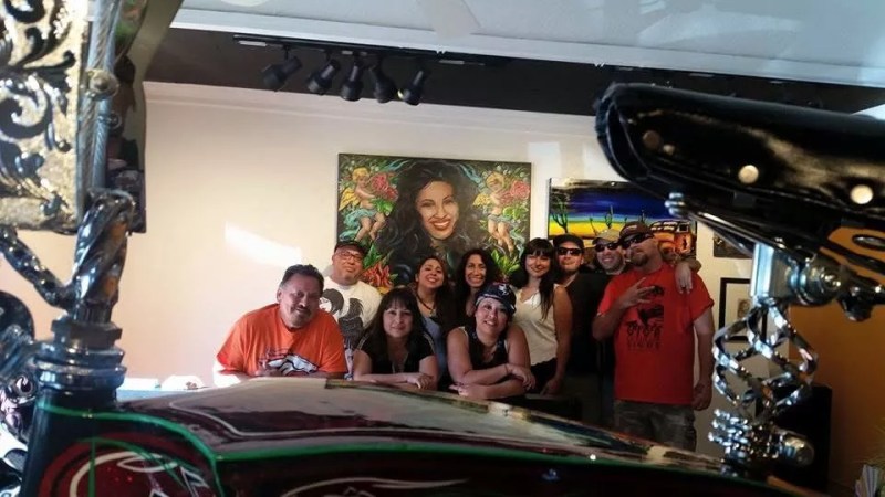 A group of people stands together in an art gallery.