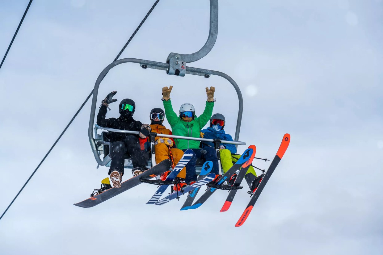 Four skiers on a Breckenridge Ski Resort chair lift
