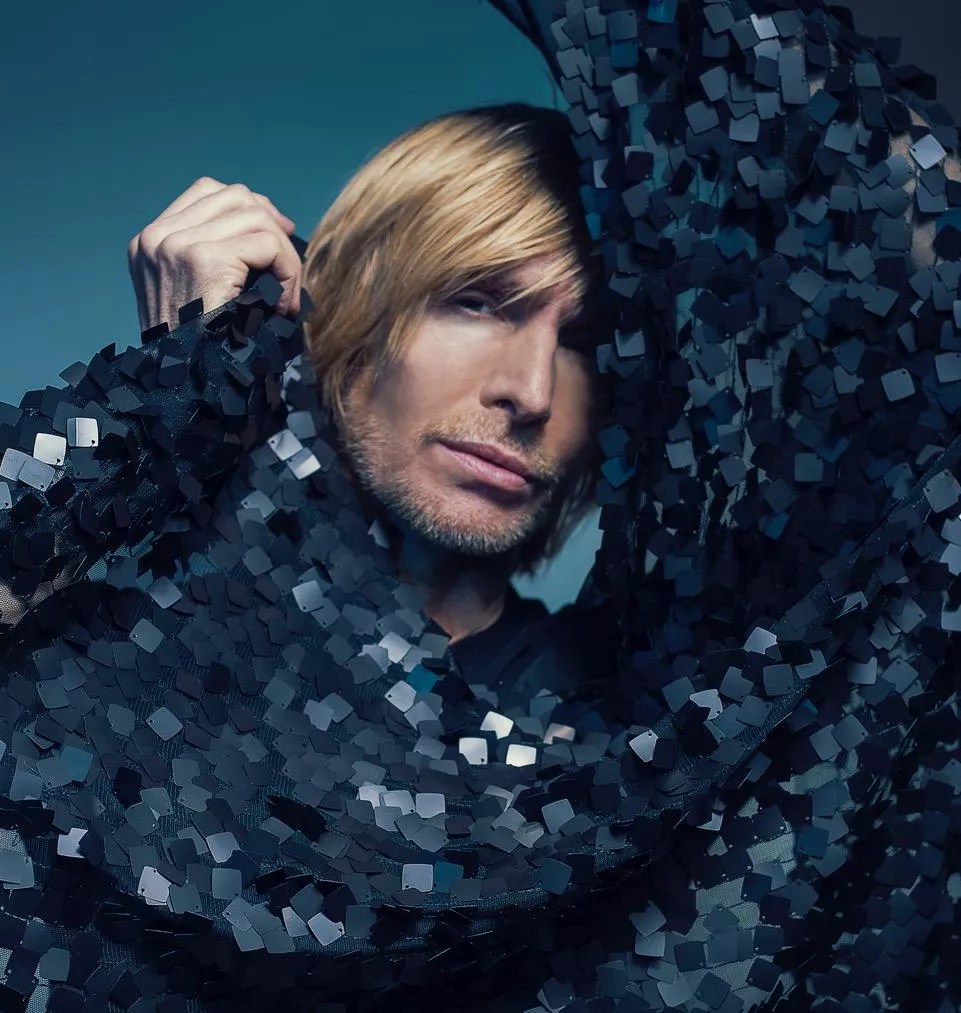 A man in a black sparkly outfit