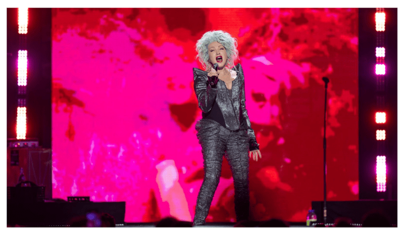 Cyndi Lauper singing on stage