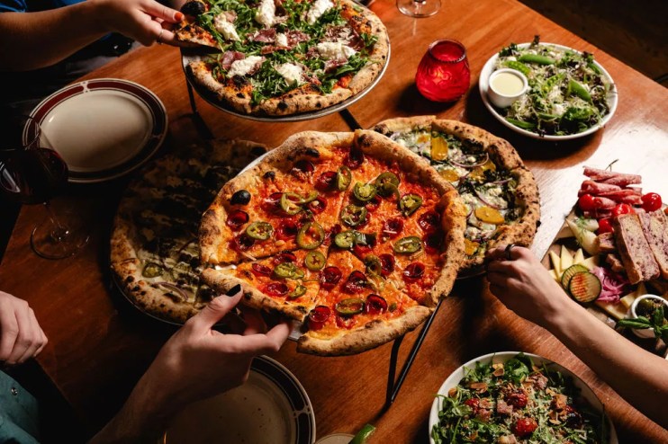 various pizzas on a table