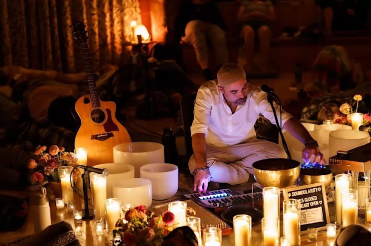 man playing singing bowls