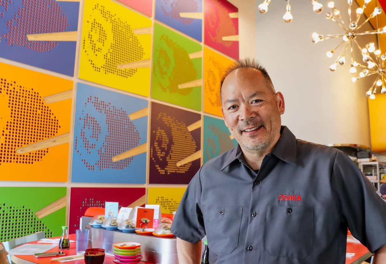 man in front of a brightly colored mural