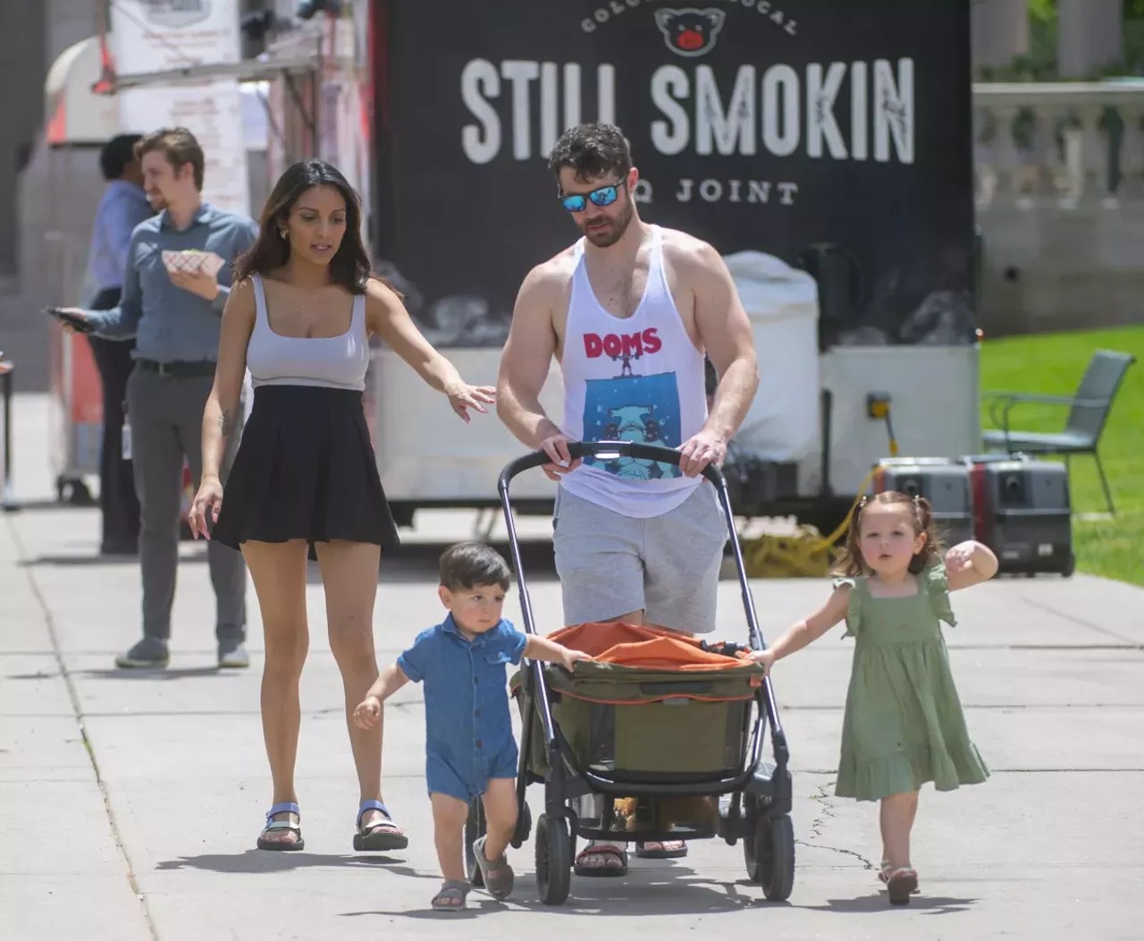 Family walks in park during summer