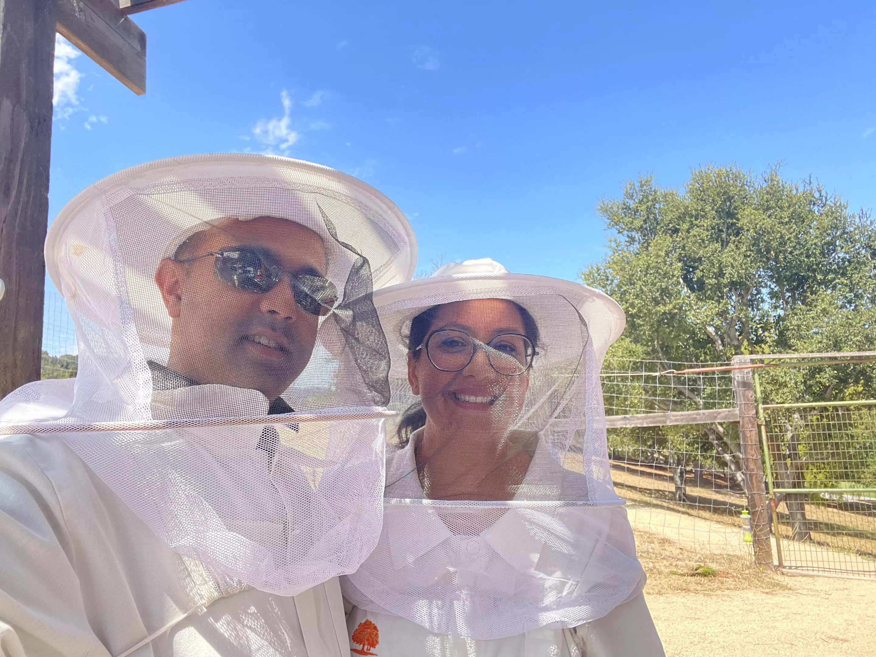 Husband and wife in beekeeping gear