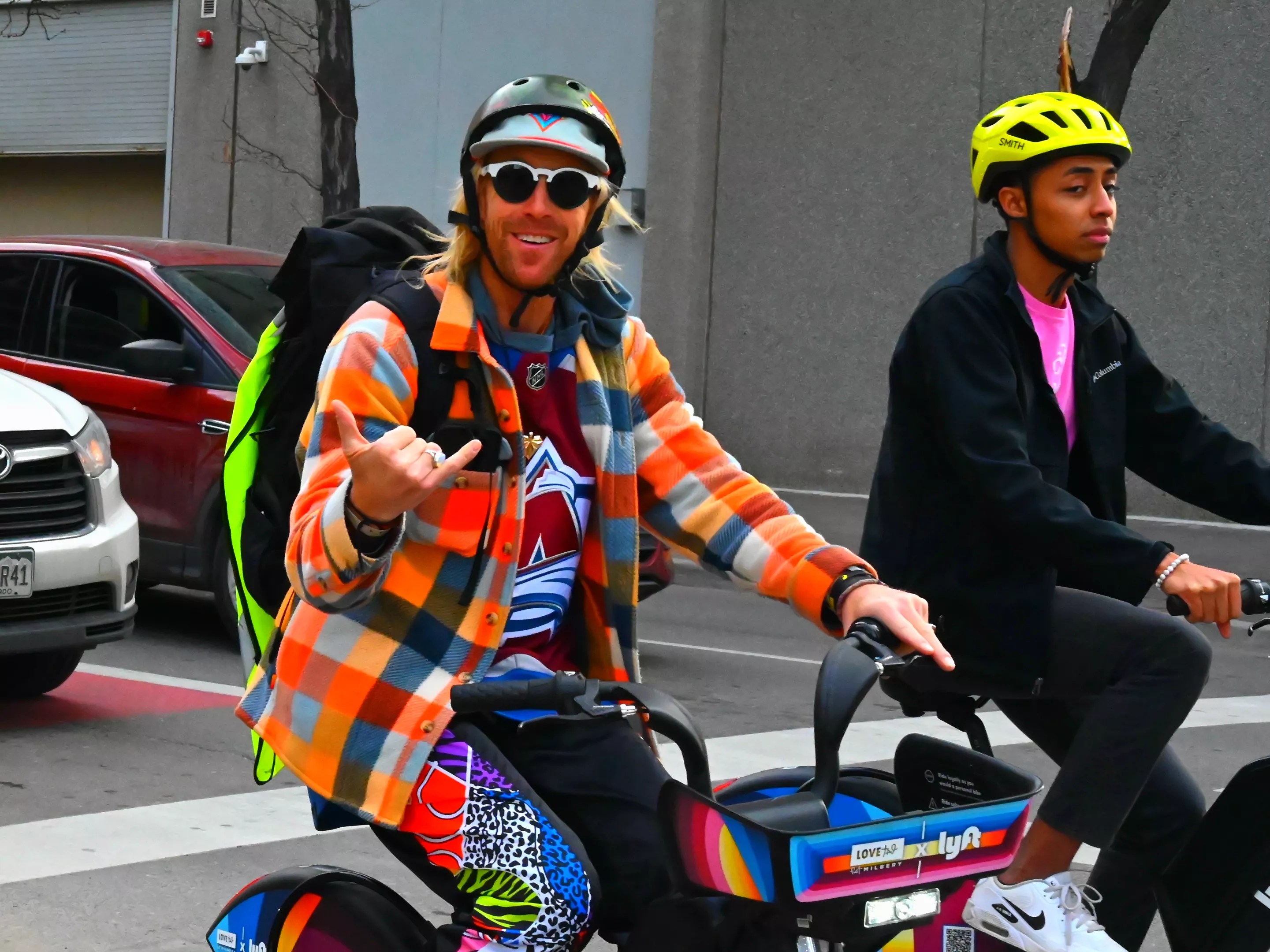 A trippy man rides a bike.