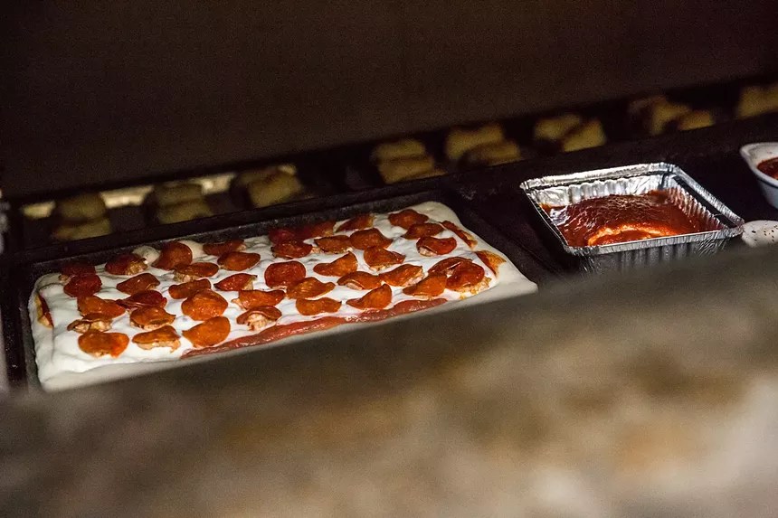 square pizzas coming out of oven