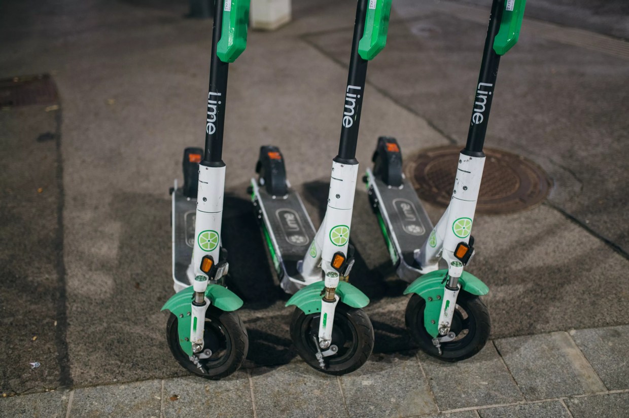 Lime scooters parked on curb