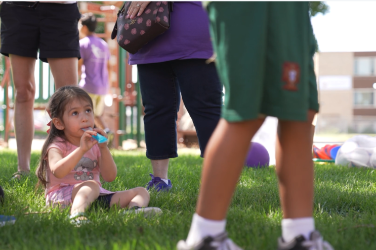 A kid looks up and eats a treat.