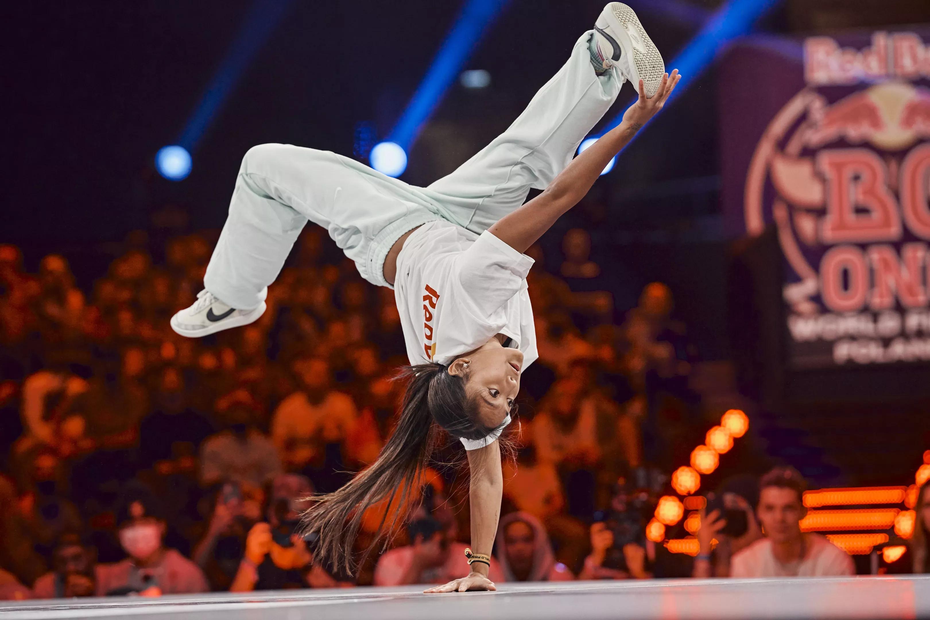 A woman breakdances.