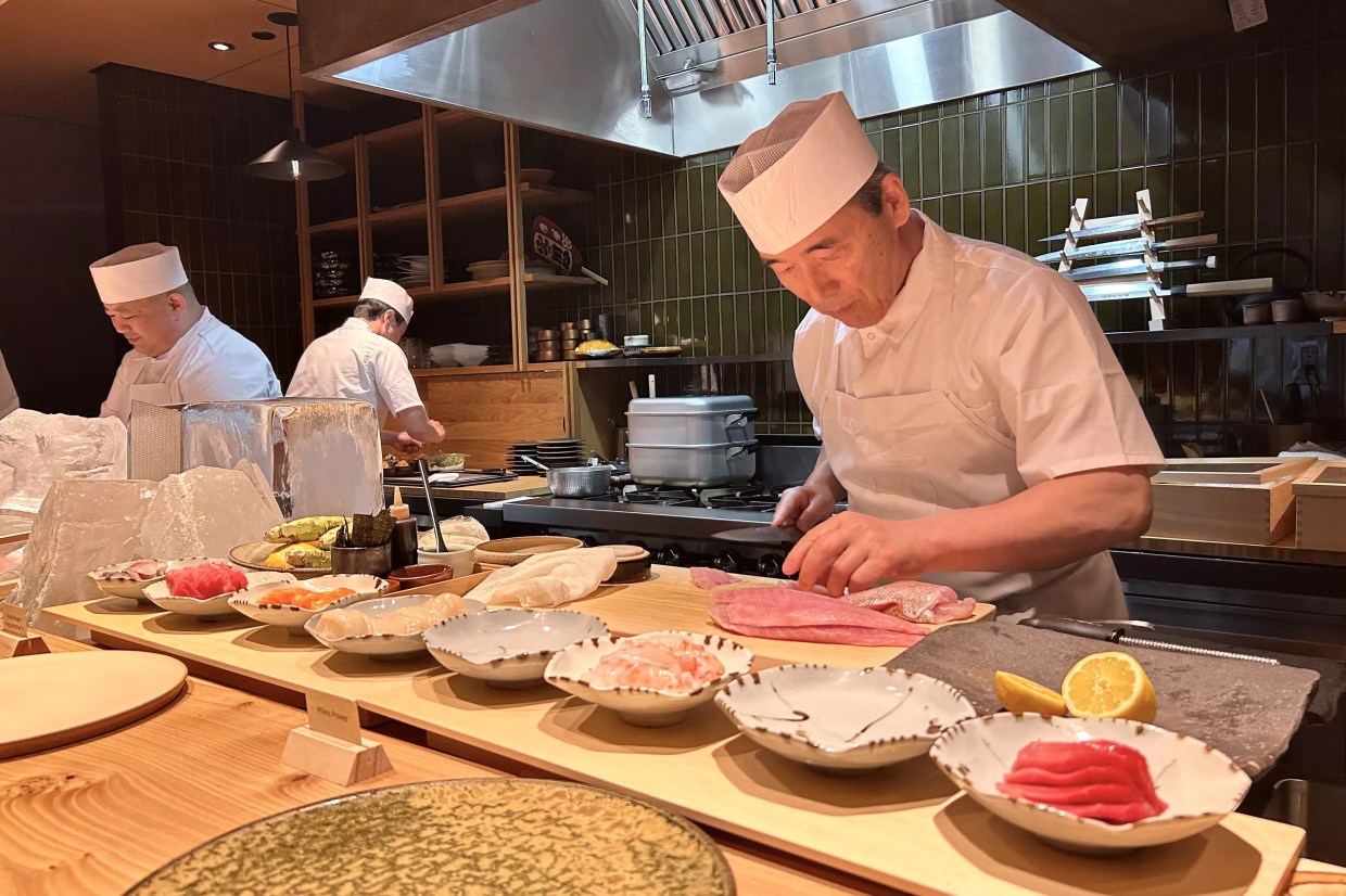Toshi Kizaki preparing raw fish at the omakase counter