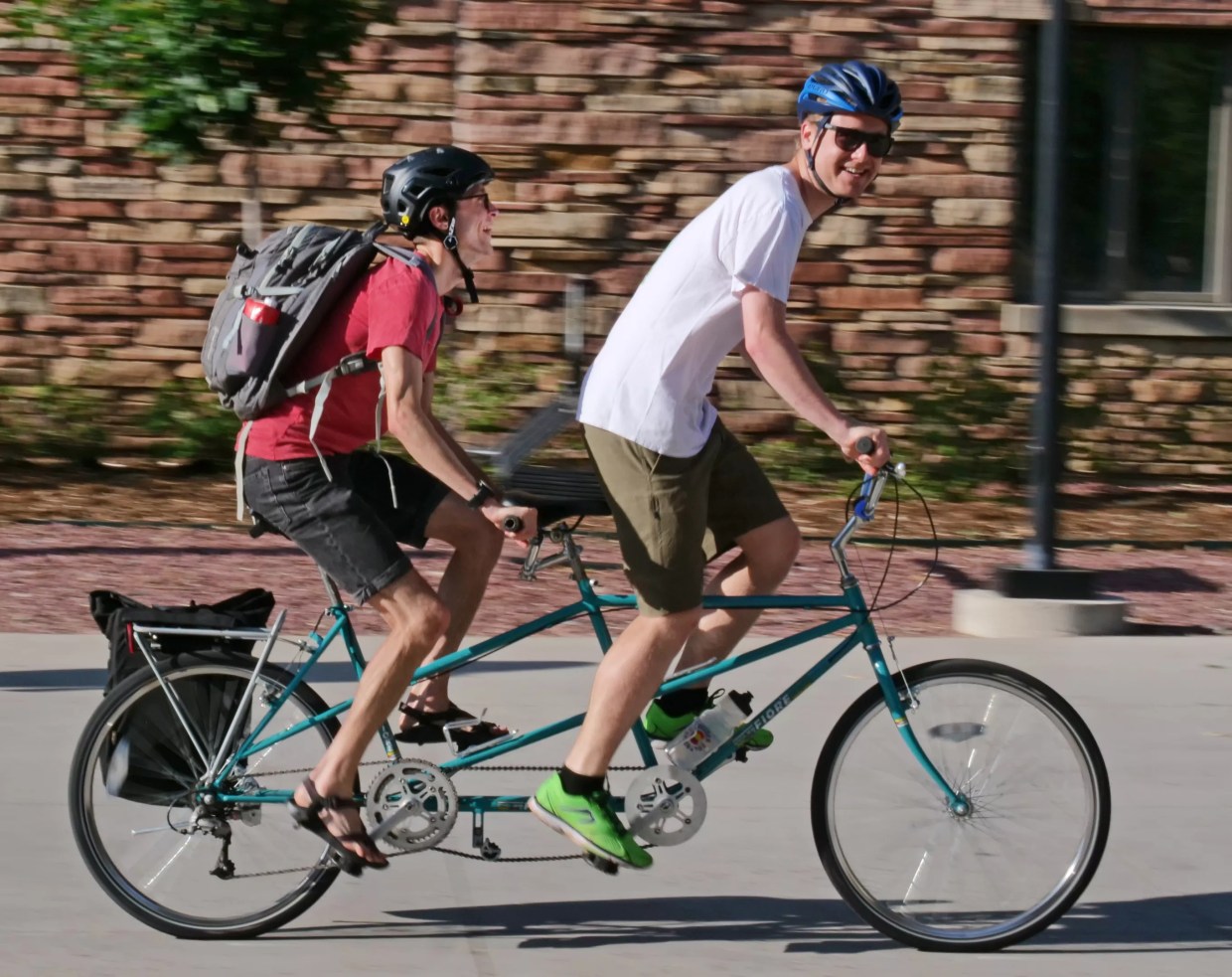 Two people riding on a tandem bicycle in Boulder