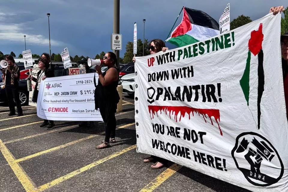 Protesters hold signs