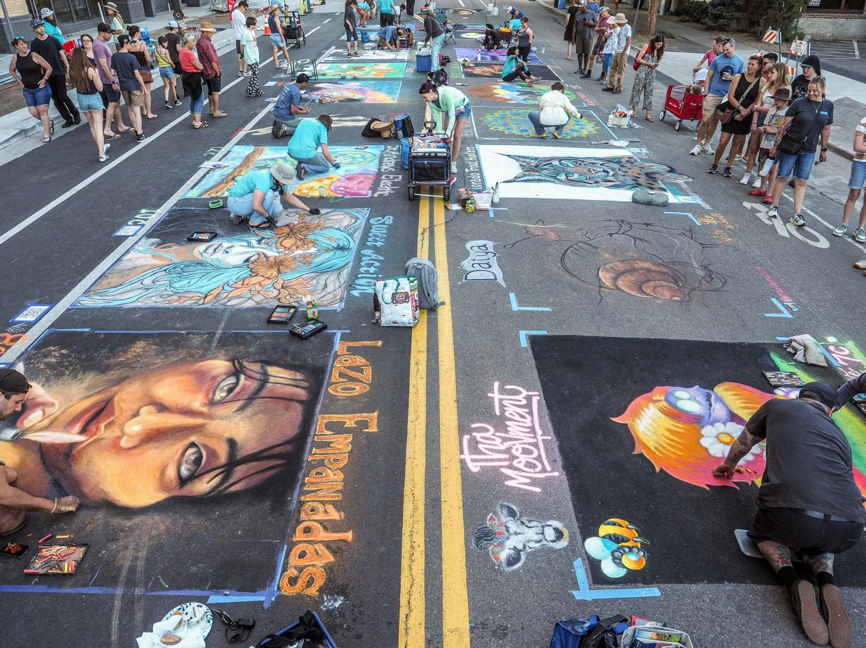 People use chalk to create street paintings.