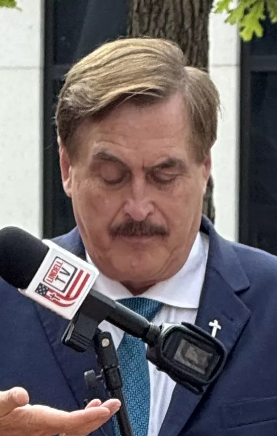 Mike Lindell in prayer before his defamation trial began on Monday in a Denver federal courthouse