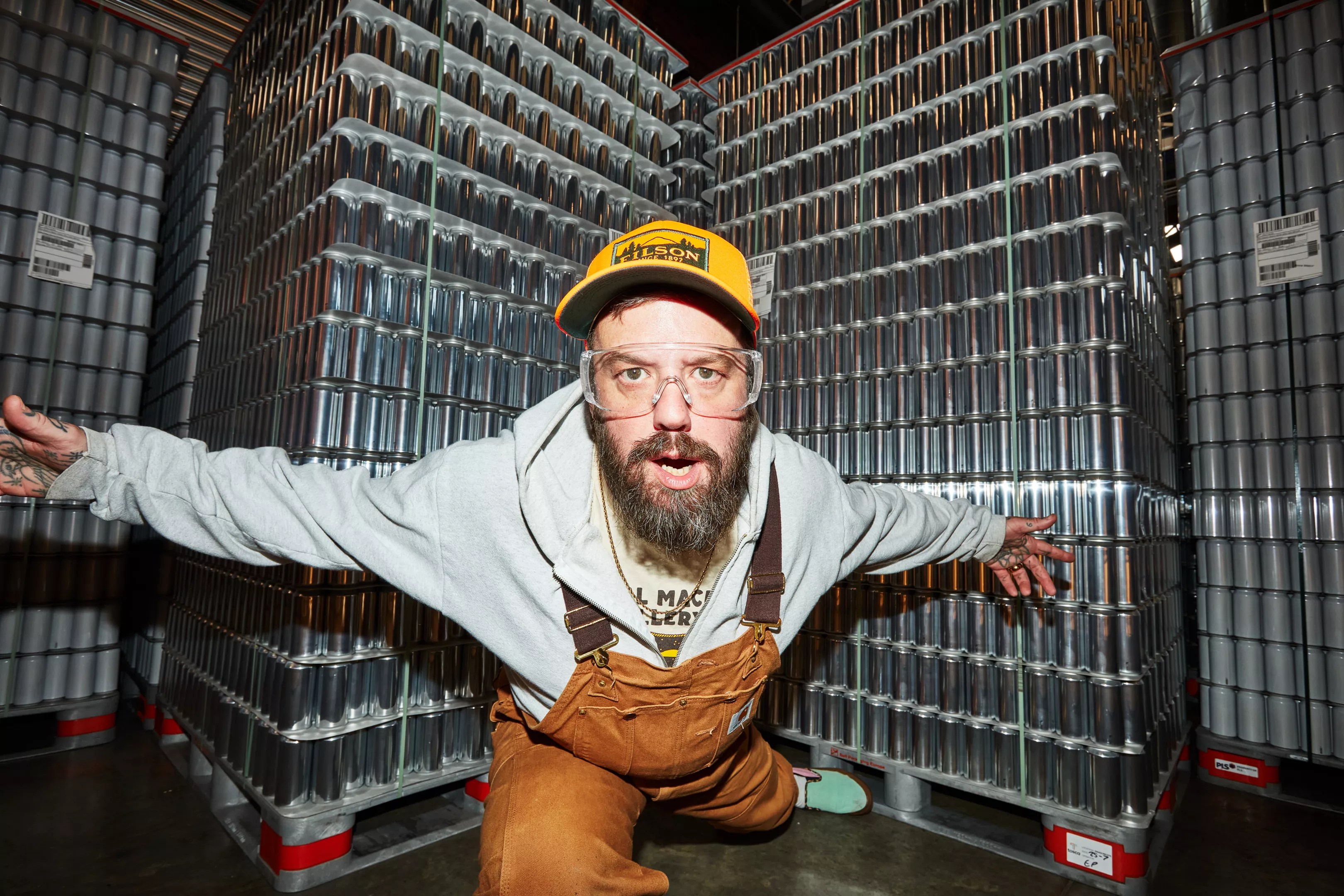 Jordan Childs posed in front of pallets of aluminum beer cans