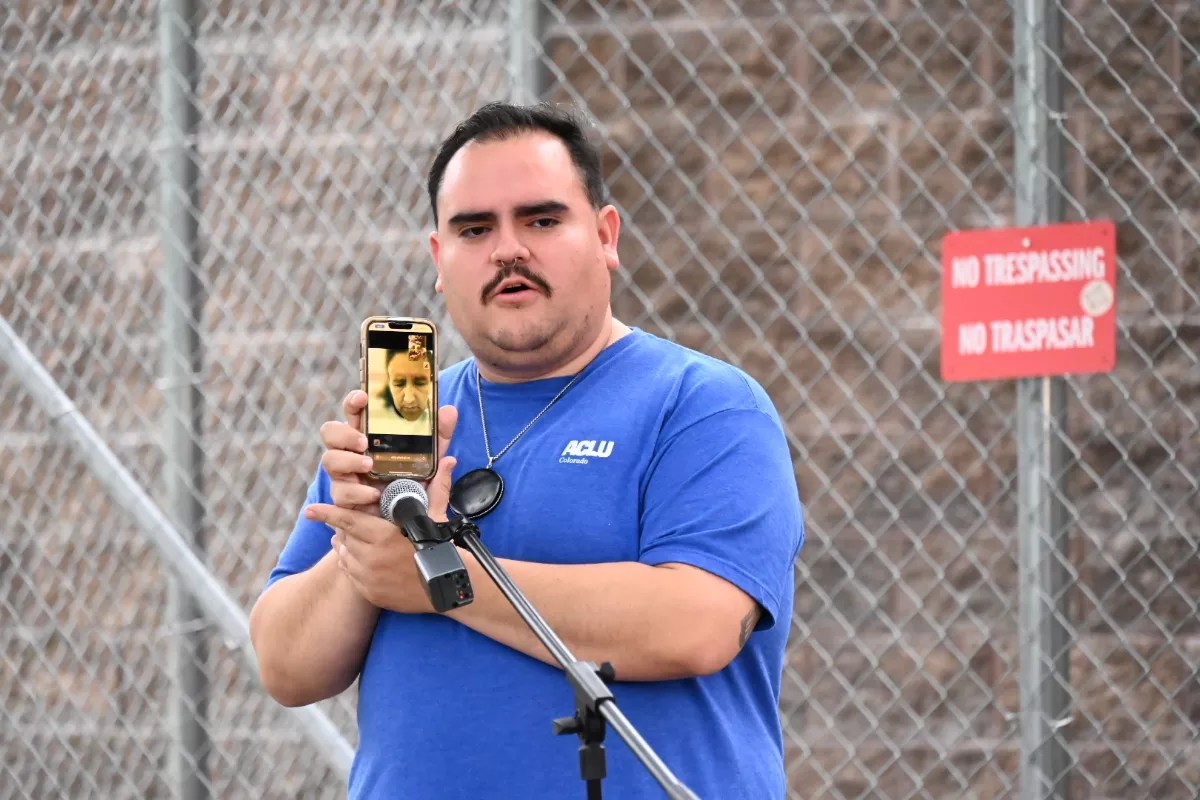 A man holds up a phone.