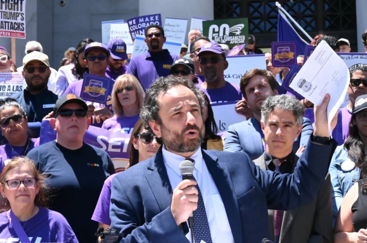 A lawyer holds up papers.