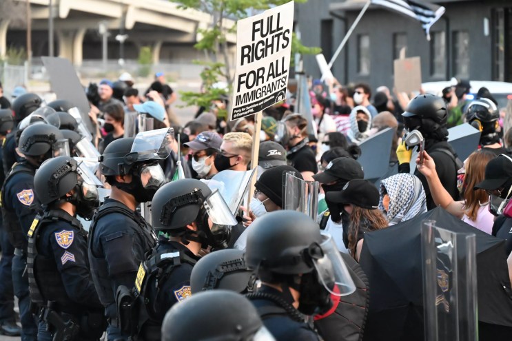 Protesters face off with police.