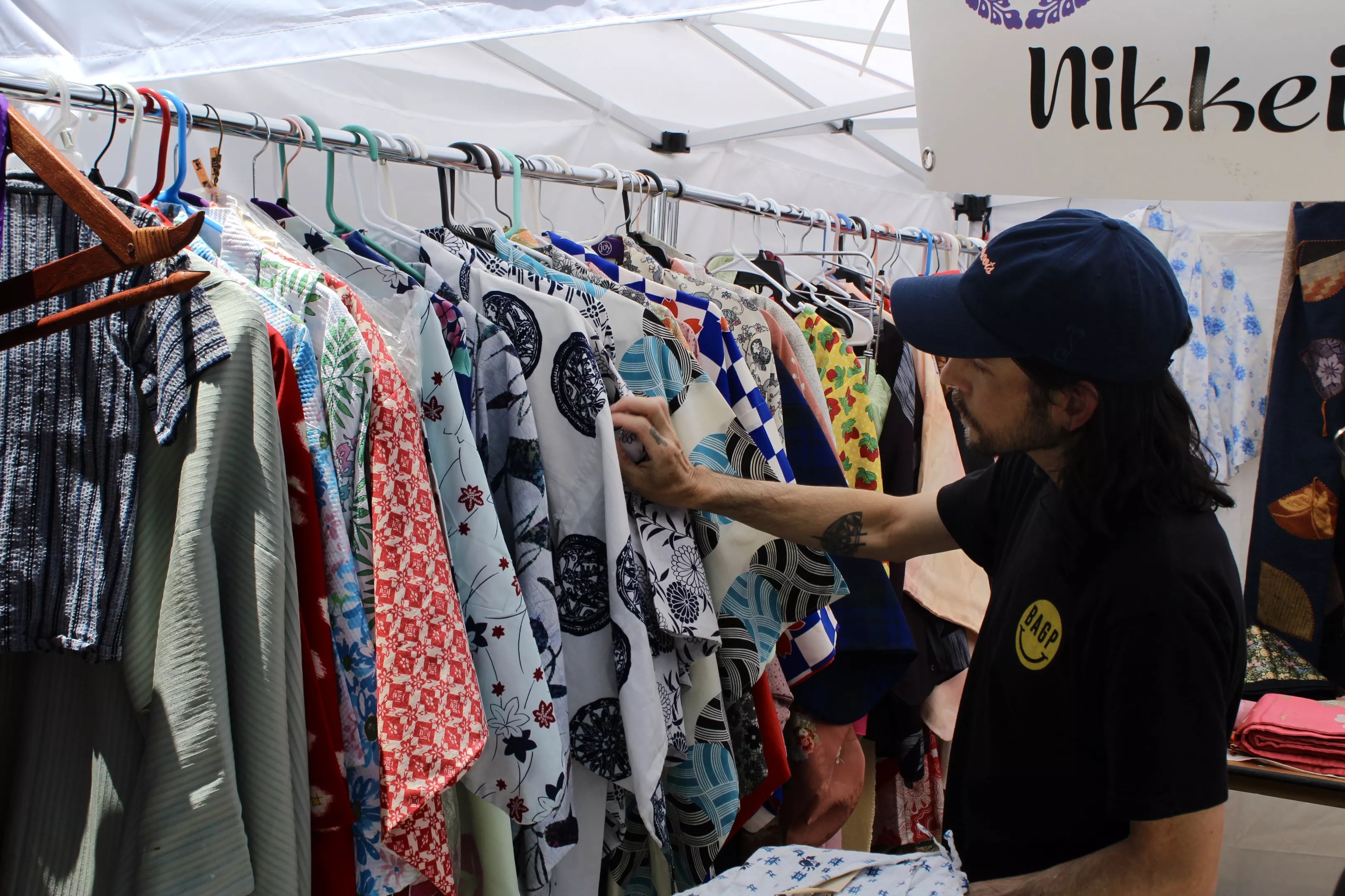 A man browses a rack of kimono