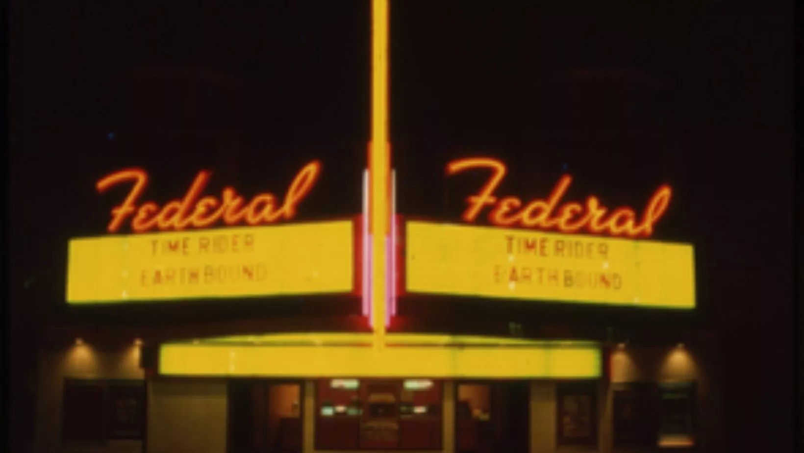 The neon marquee of the Federal Theatre in Denver at night