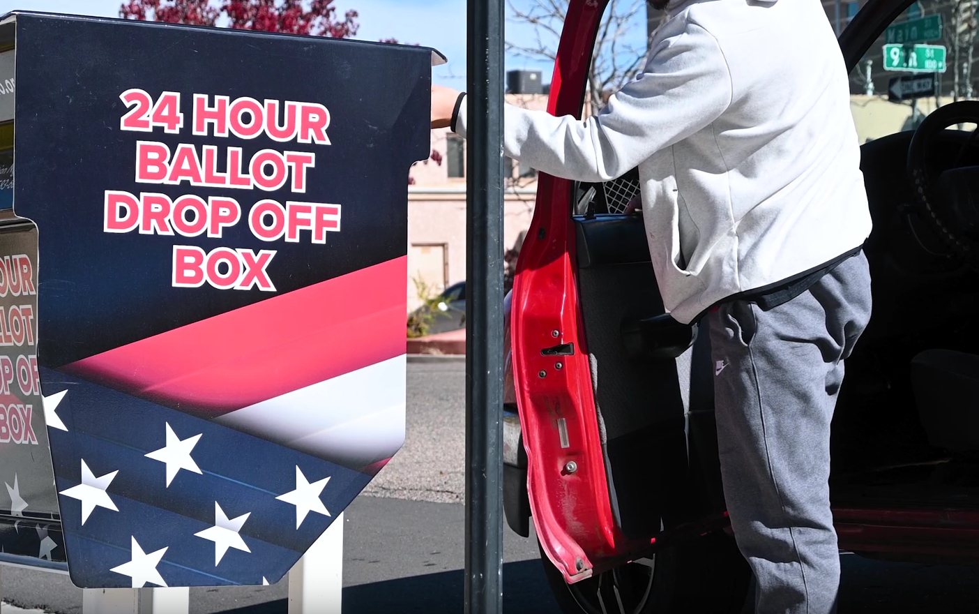 man drops off election ballot in dropoff box