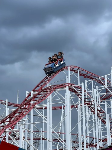 People ride a rollercoaster