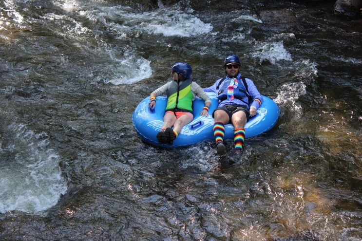 Two people in a double inner tube.