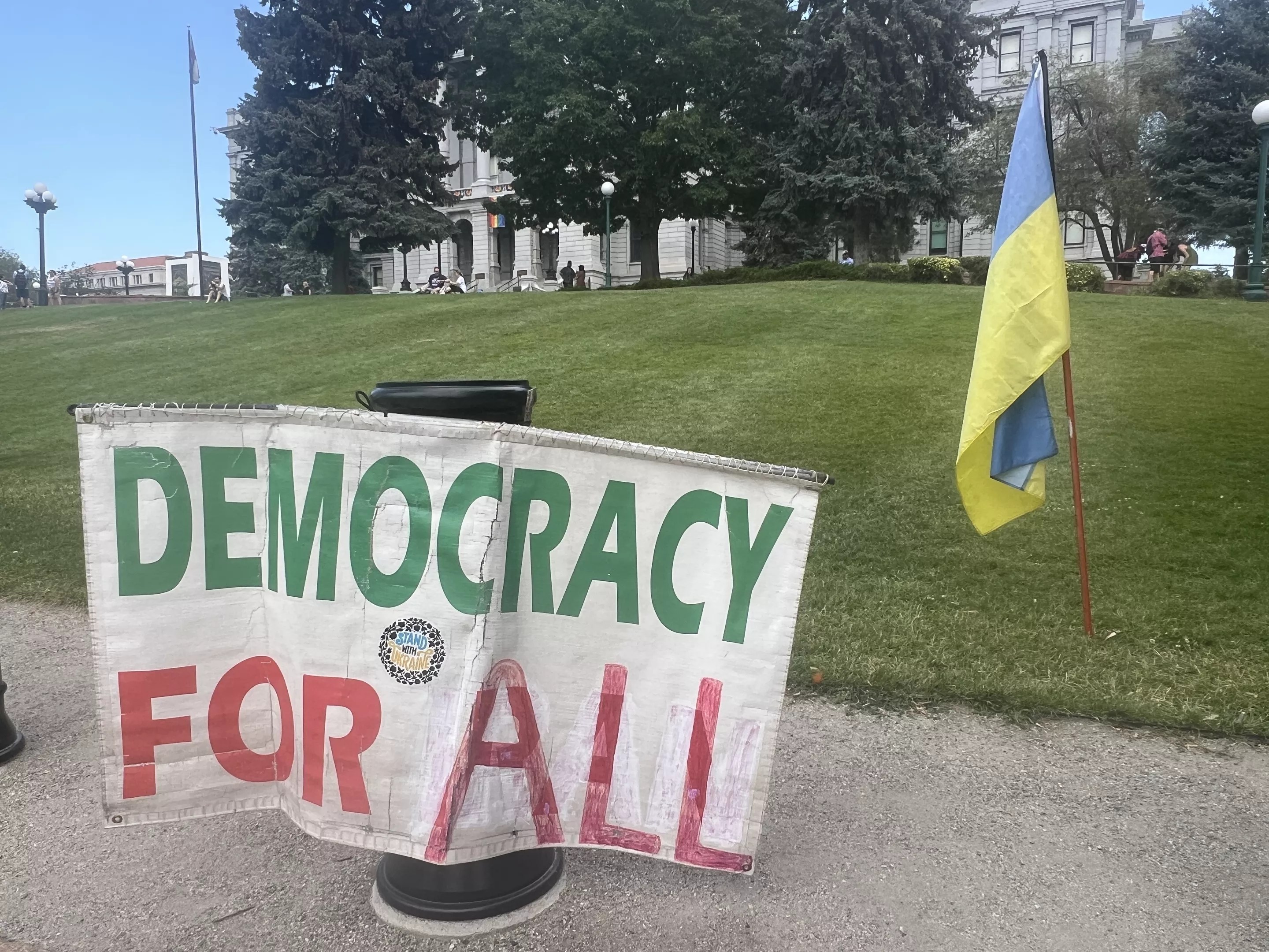 Democracy for all sign at Denver protest