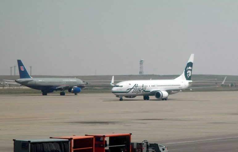 grounded united airlines and alaskan airlines planes on runway