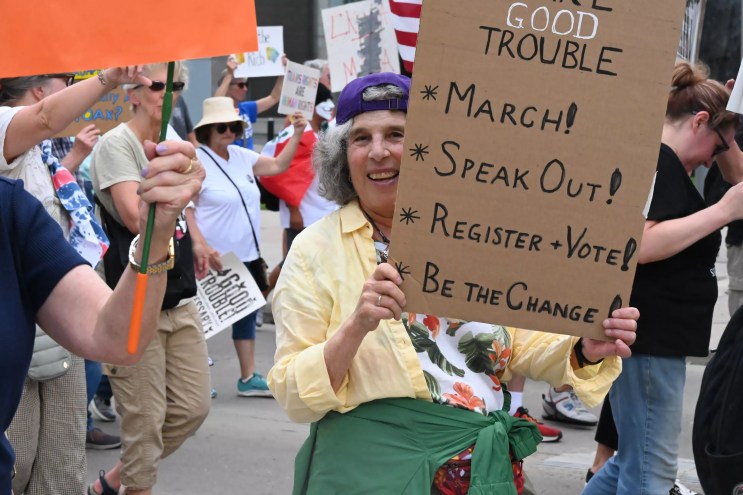 A protester holds up a sign.