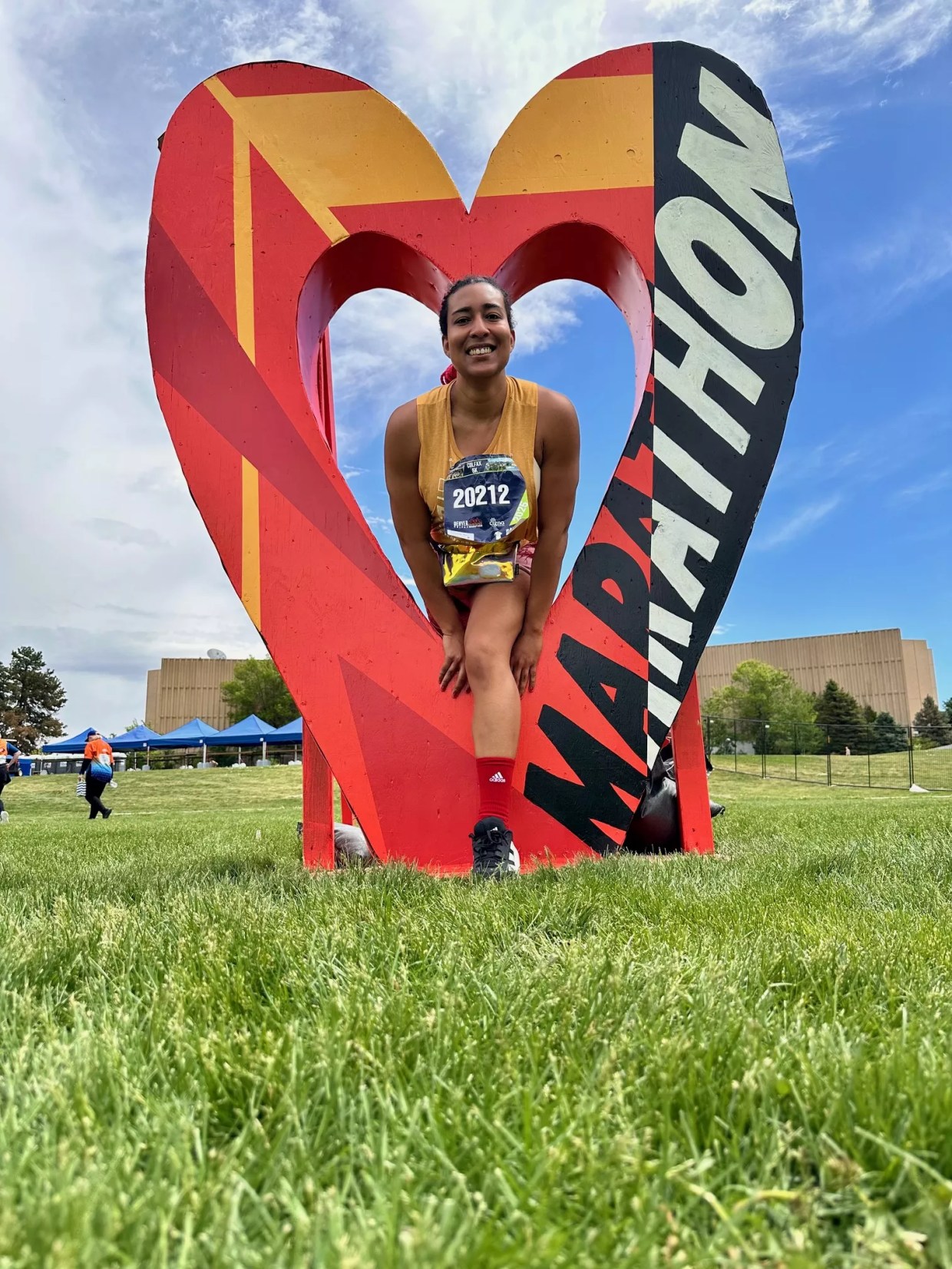 A photo of a woman in a heart sculpture