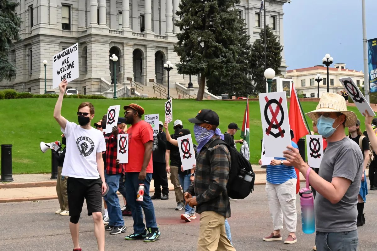 A small group of protesters march.