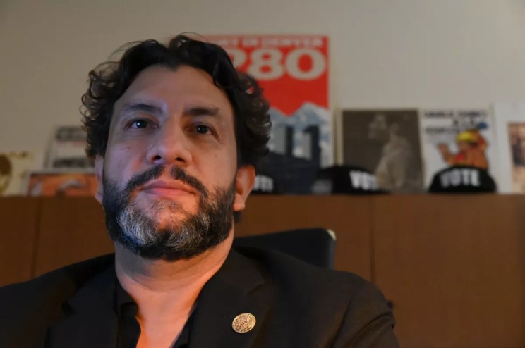 Paul López sits in his office.