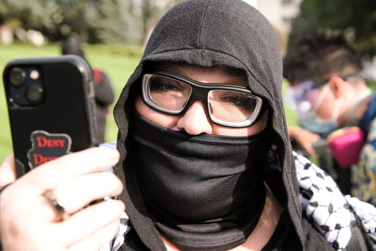 A woman yells towards a camera.