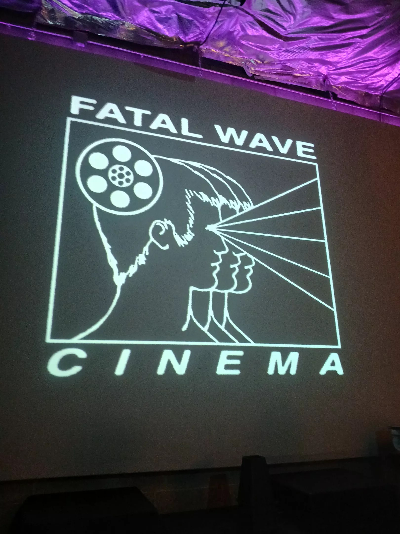 A sign reading "Fatal Wave Cinema"